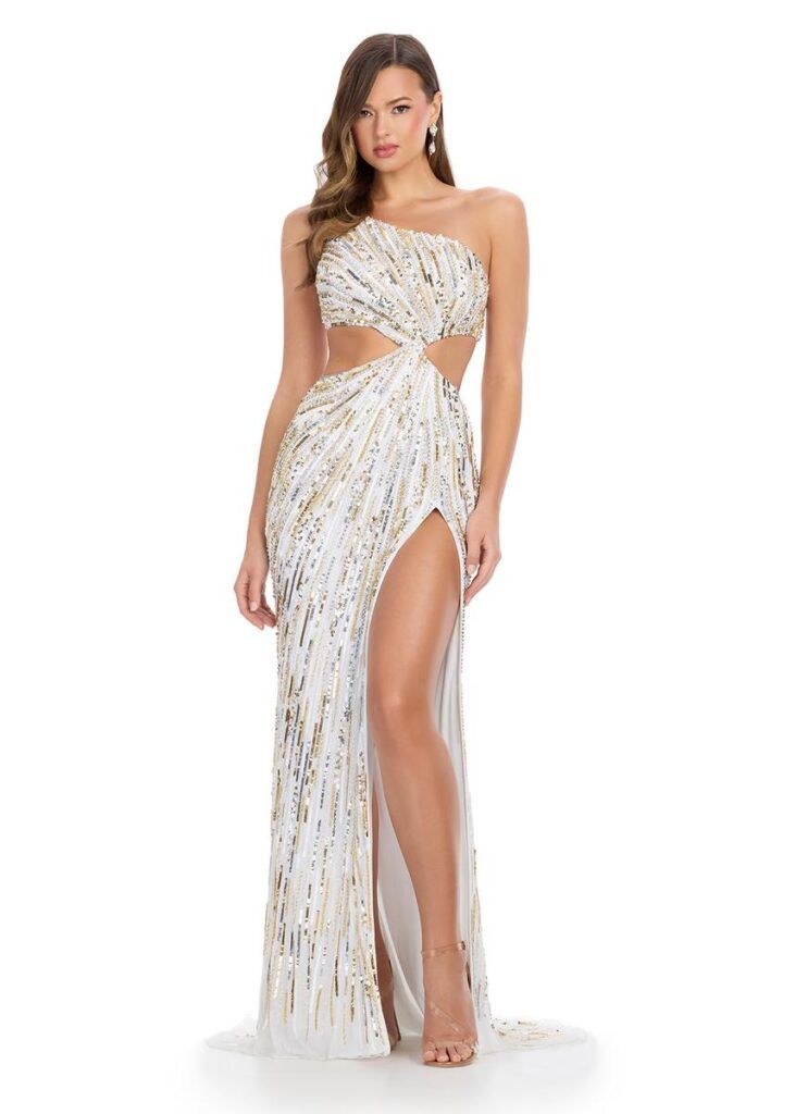Model in a white, beaded one-shoulder gown with a thigh-high slit and flowing train.