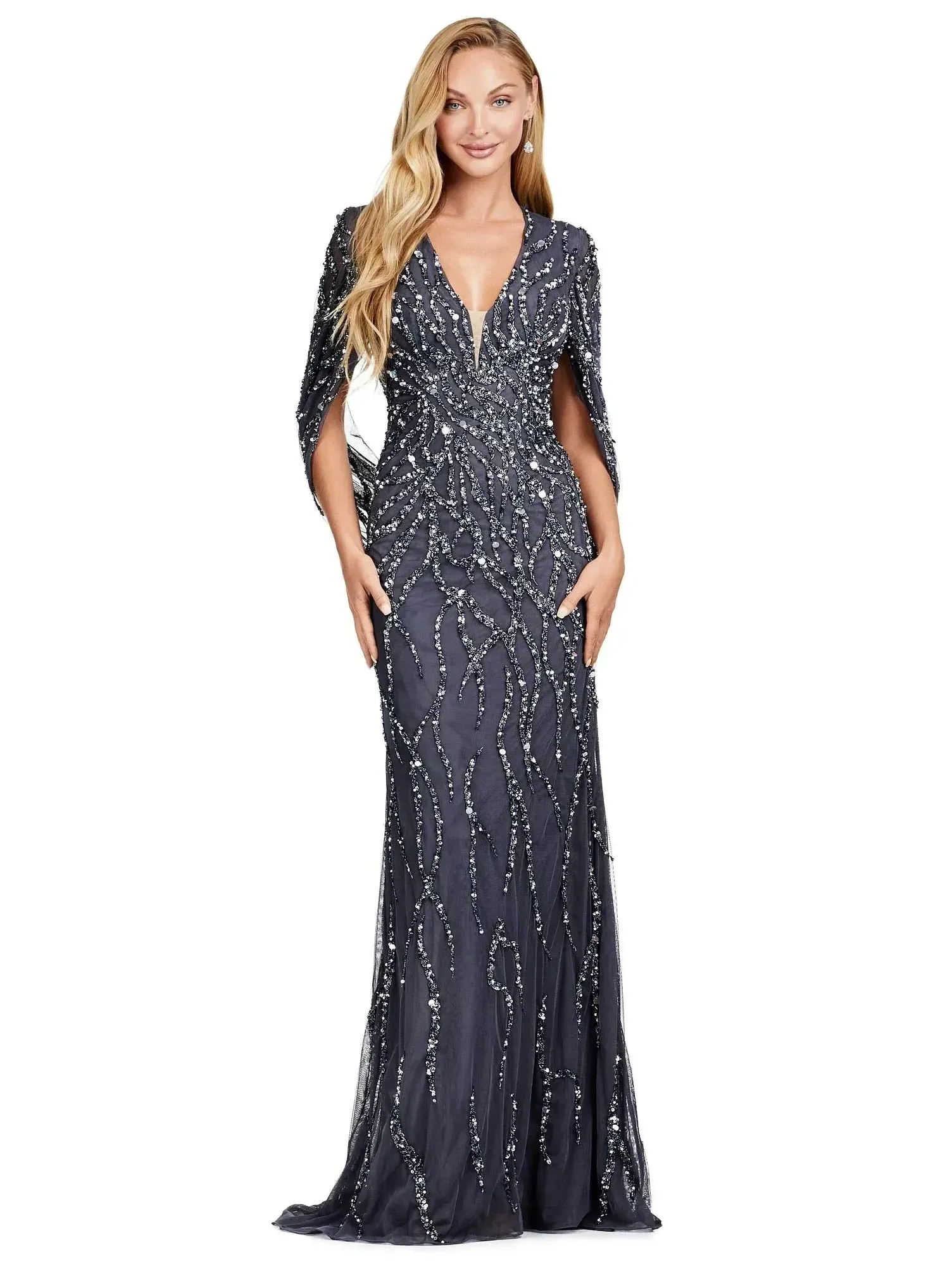 Woman in a navy sequined evening gown with a deep V-neck and flowing skirt, posing on a white background