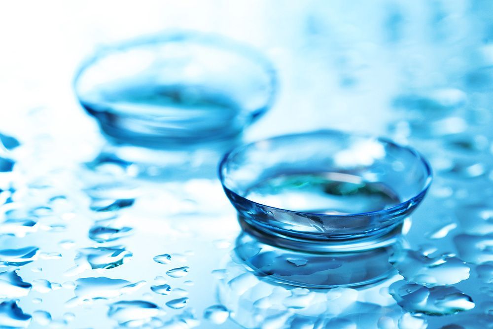 Two clear glass bowls on a blue water surface with ripples