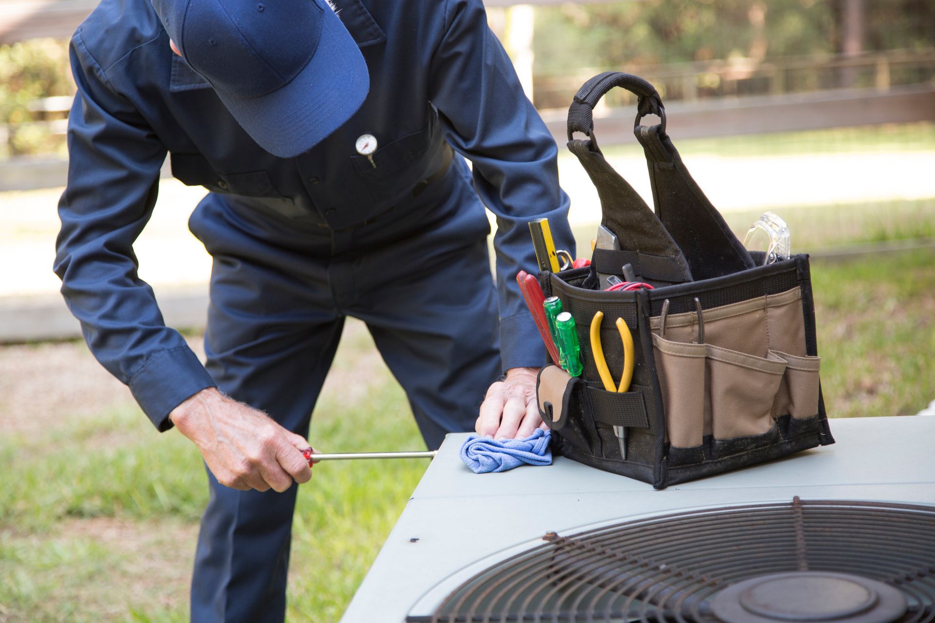 HVAC technician performing seasonal maintenance on HVAC system in Staten Island New York.