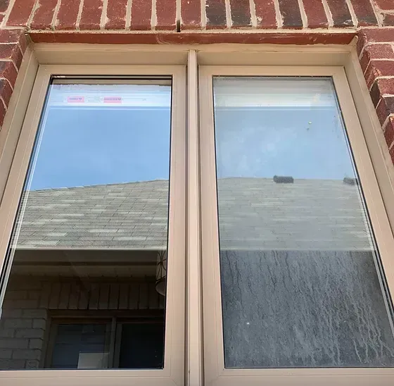 A close up of a window on a brick building.
