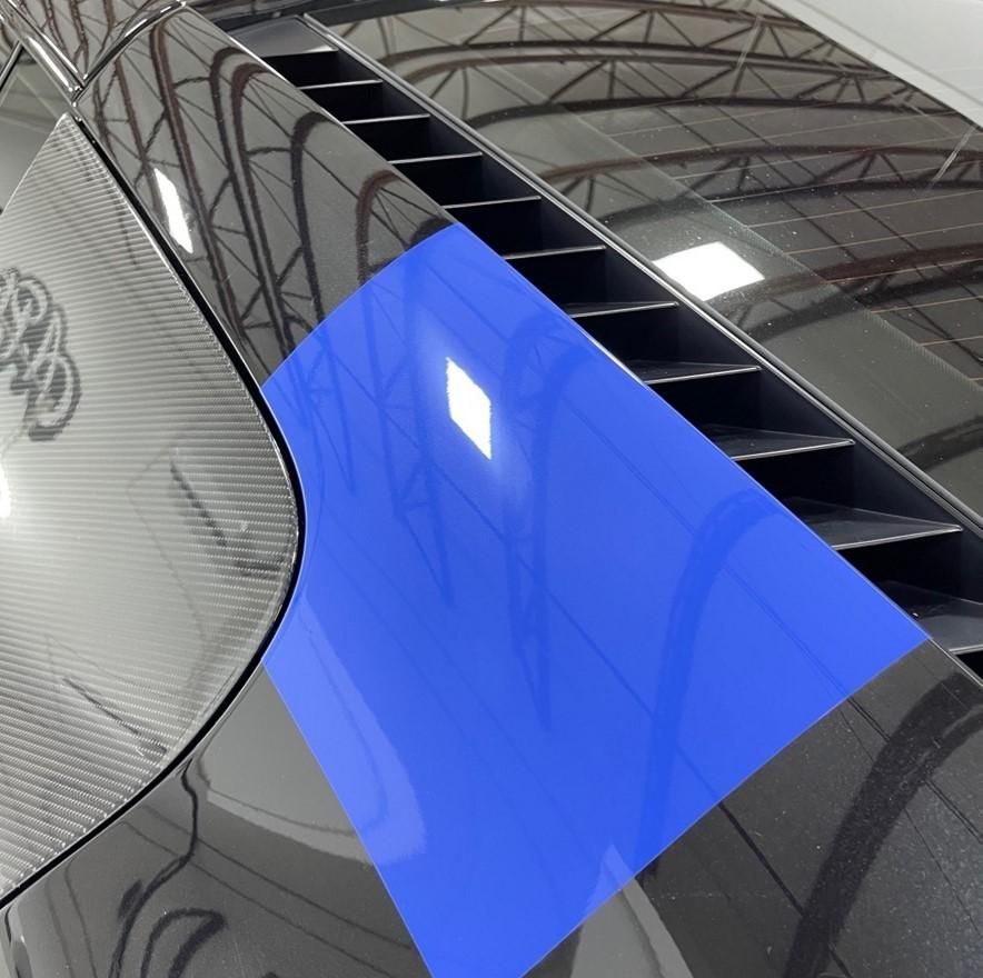A black car with a blue stripe on the side