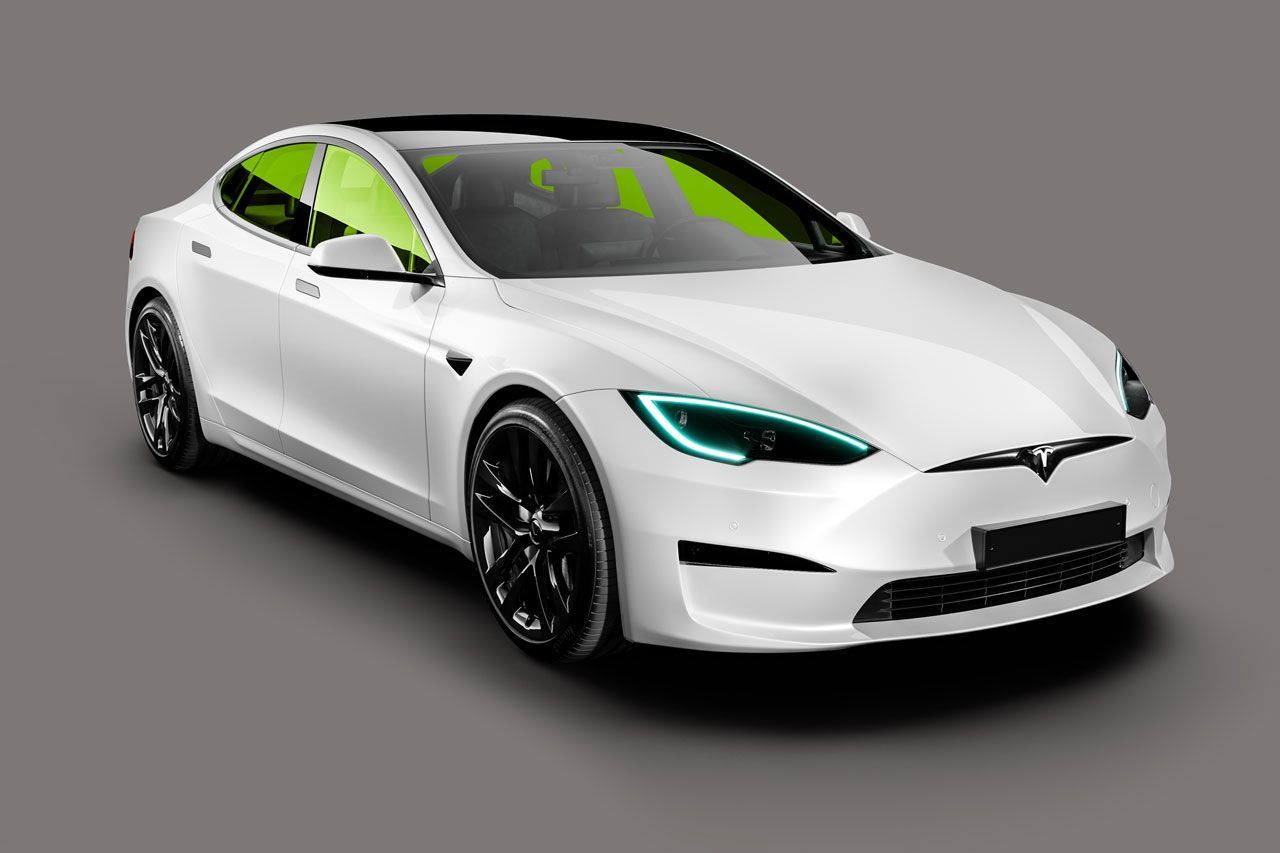 A white tesla model s with green lights on a gray background.