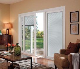 A living room with sliding glass doors leading to a patio.