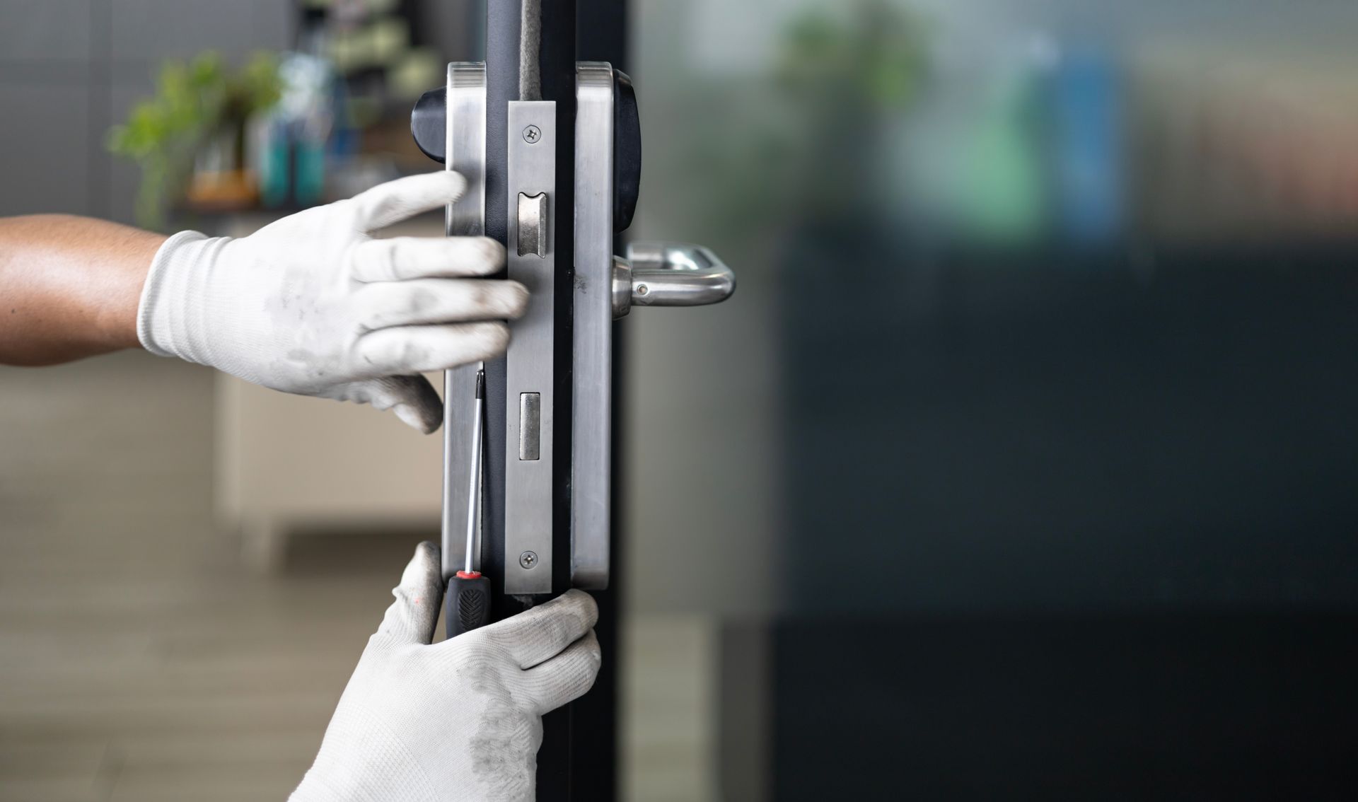 Worker repairs an entry door.