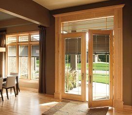 A living room with a dining table and chairs and a sliding glass door leading to a patio.