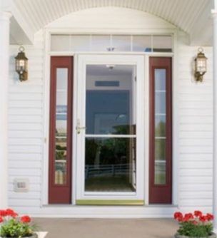 A white house with red doors and a glass door