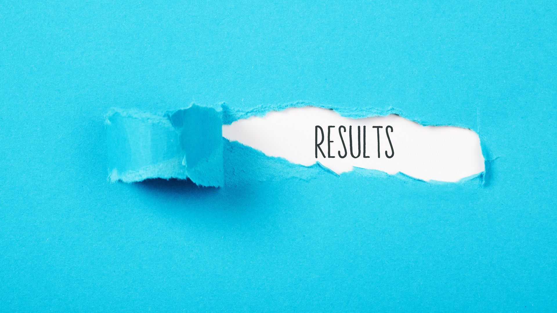 The word results is written on a piece of torn paper.