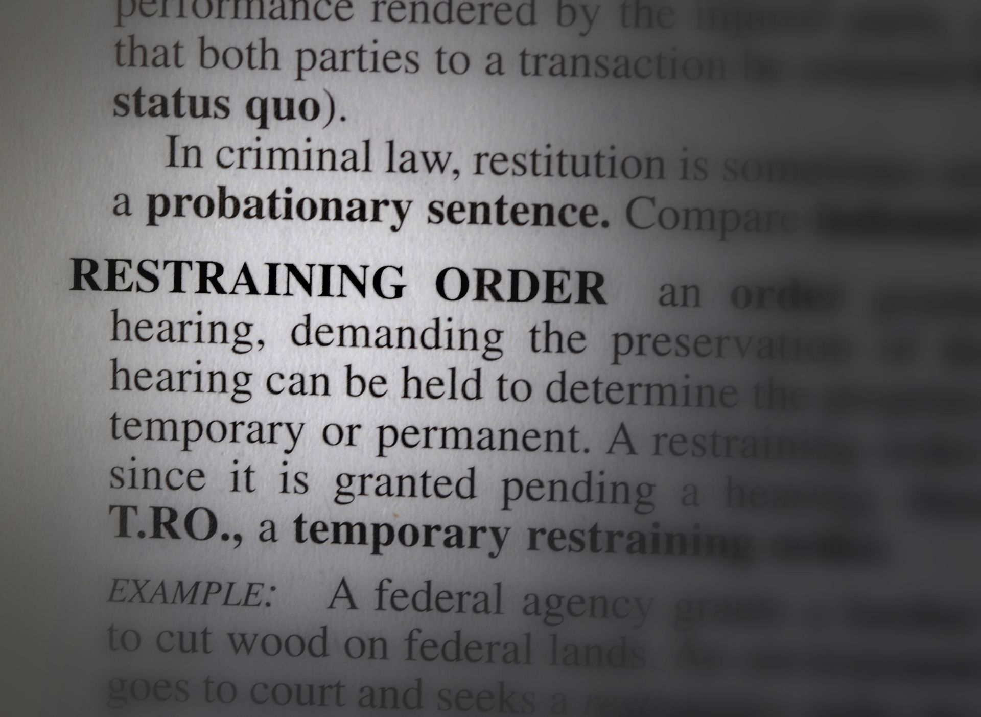 A book is open to a page that says restraining order