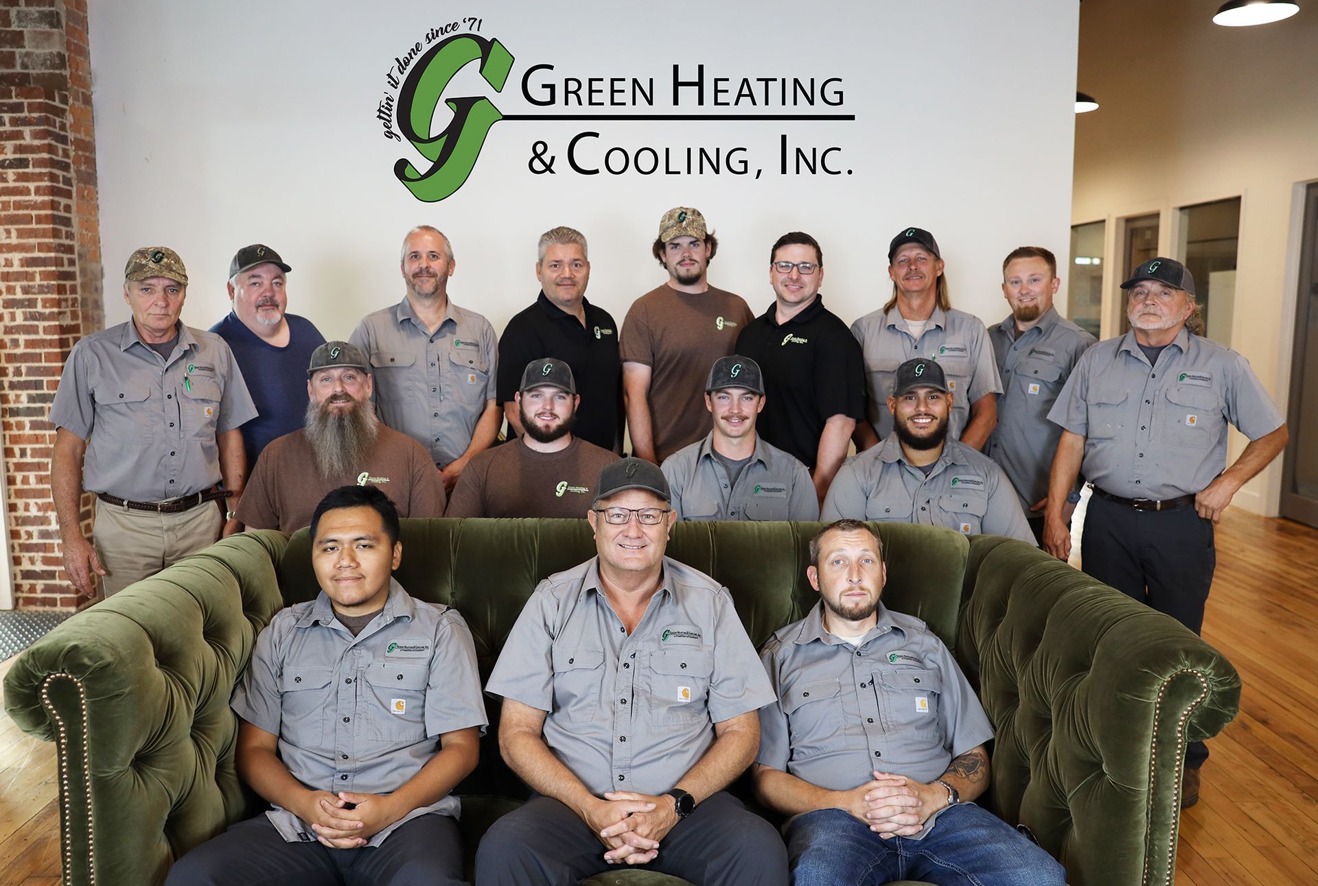 Group of 15 employees from Green Heating & Cooling, Inc., posing for a photo.