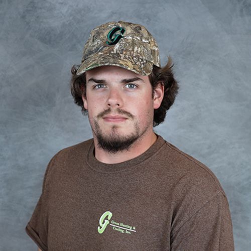 Man wearing camouflage cap and brown t-shirt with a