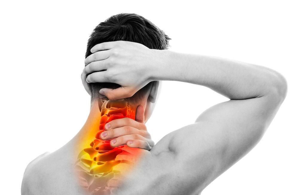 A man is holding his neck in pain.