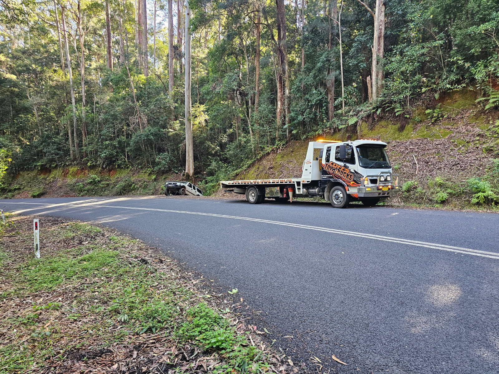 Tow Truck Parked On A Winding Forest Road  — Coffs Tow Trucks In North Boambee Valley, NSW