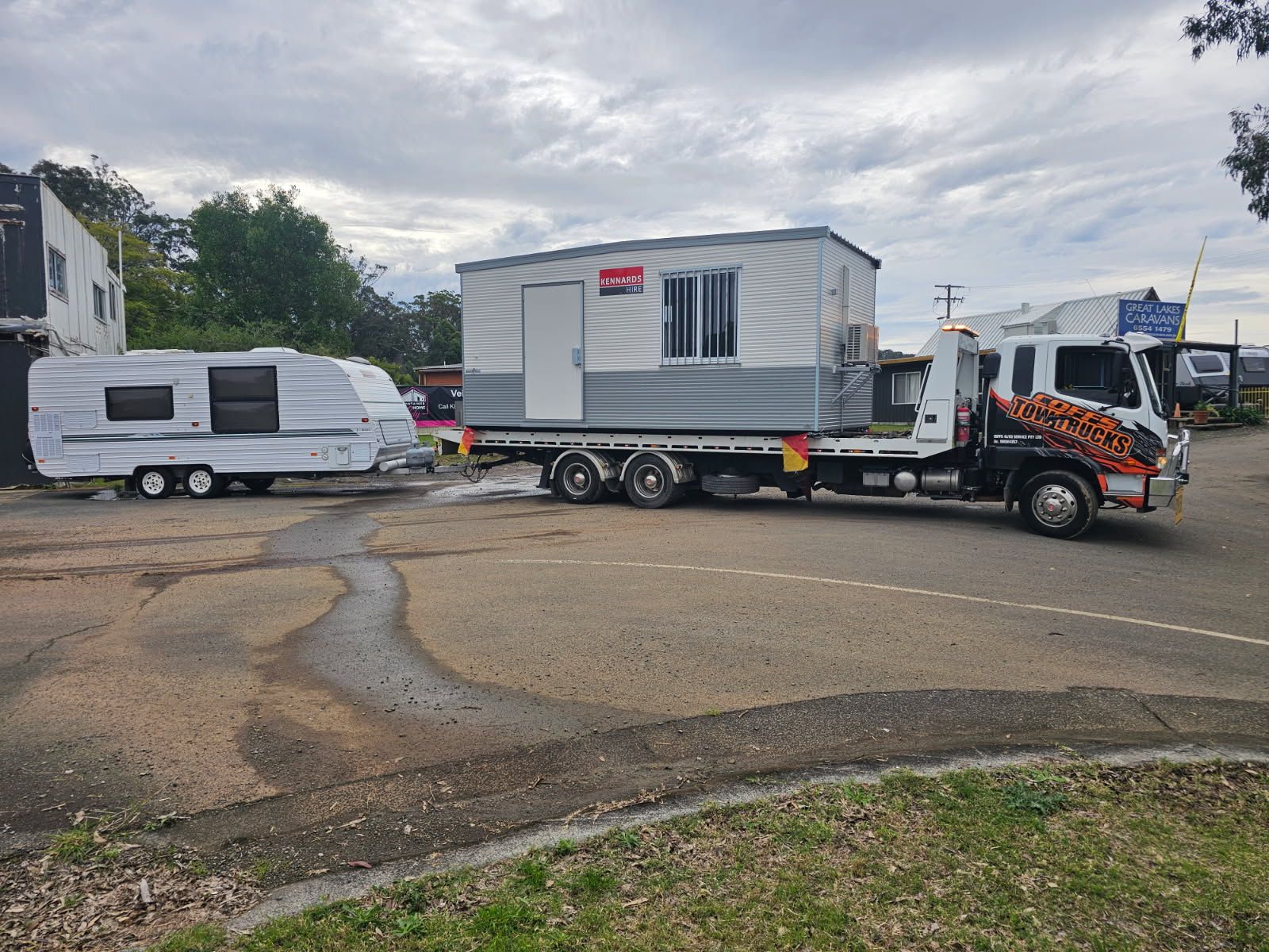 Tow Truck Hauling A White Mobile Cabin On A Trailer  — Coffs Tow Trucks In North Boambee Valley, NSW