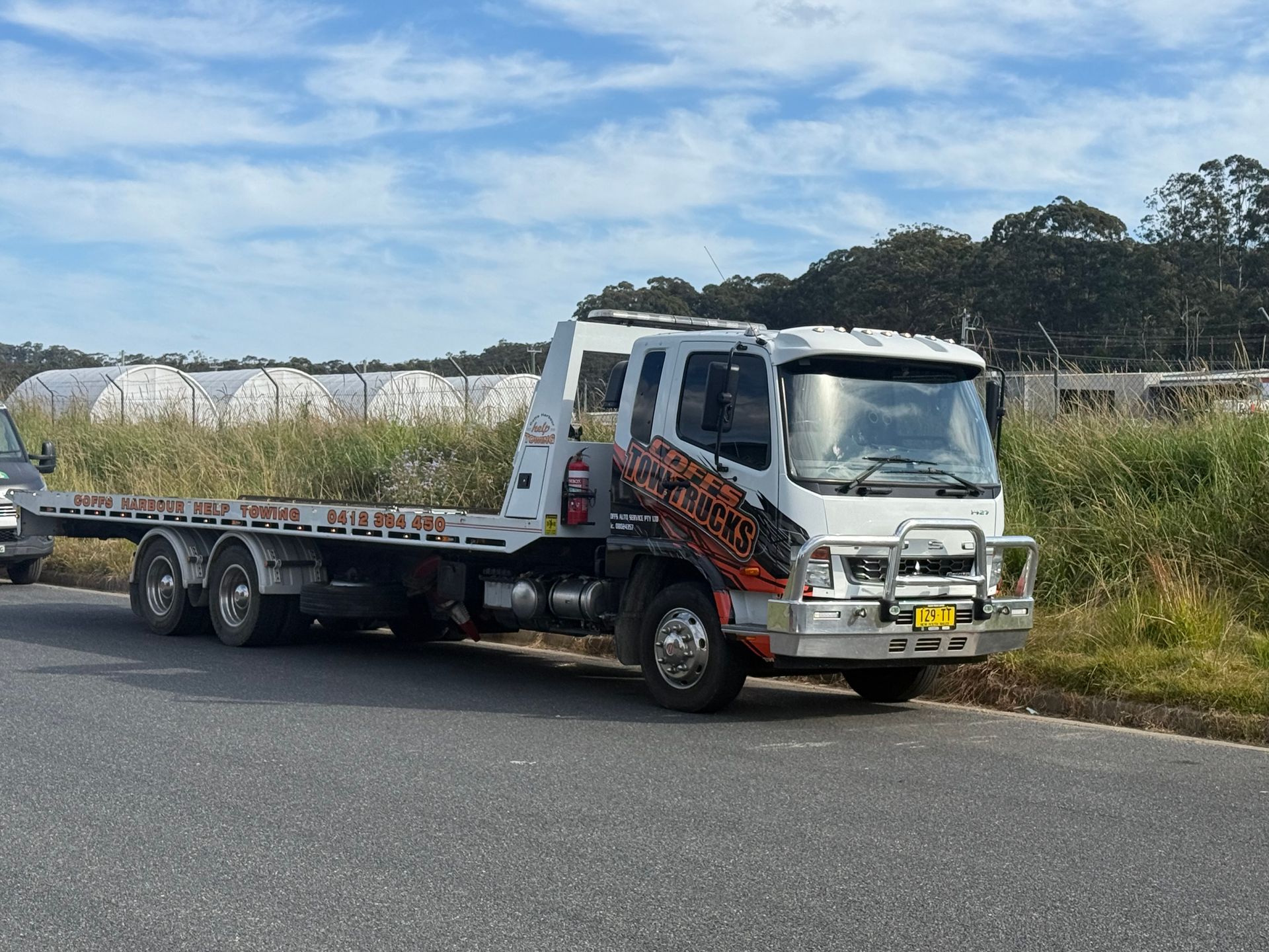 White Flatbed Truck Parked On Roadside — Coffs Tow Trucks In Woolgoolga, NSW