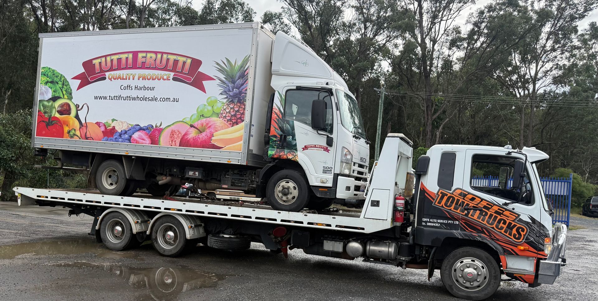 Tow Trucks Hauling A Colorful Floral Delivery Truck — Coffs Tow Trucks In North Boambee Valley, NSW