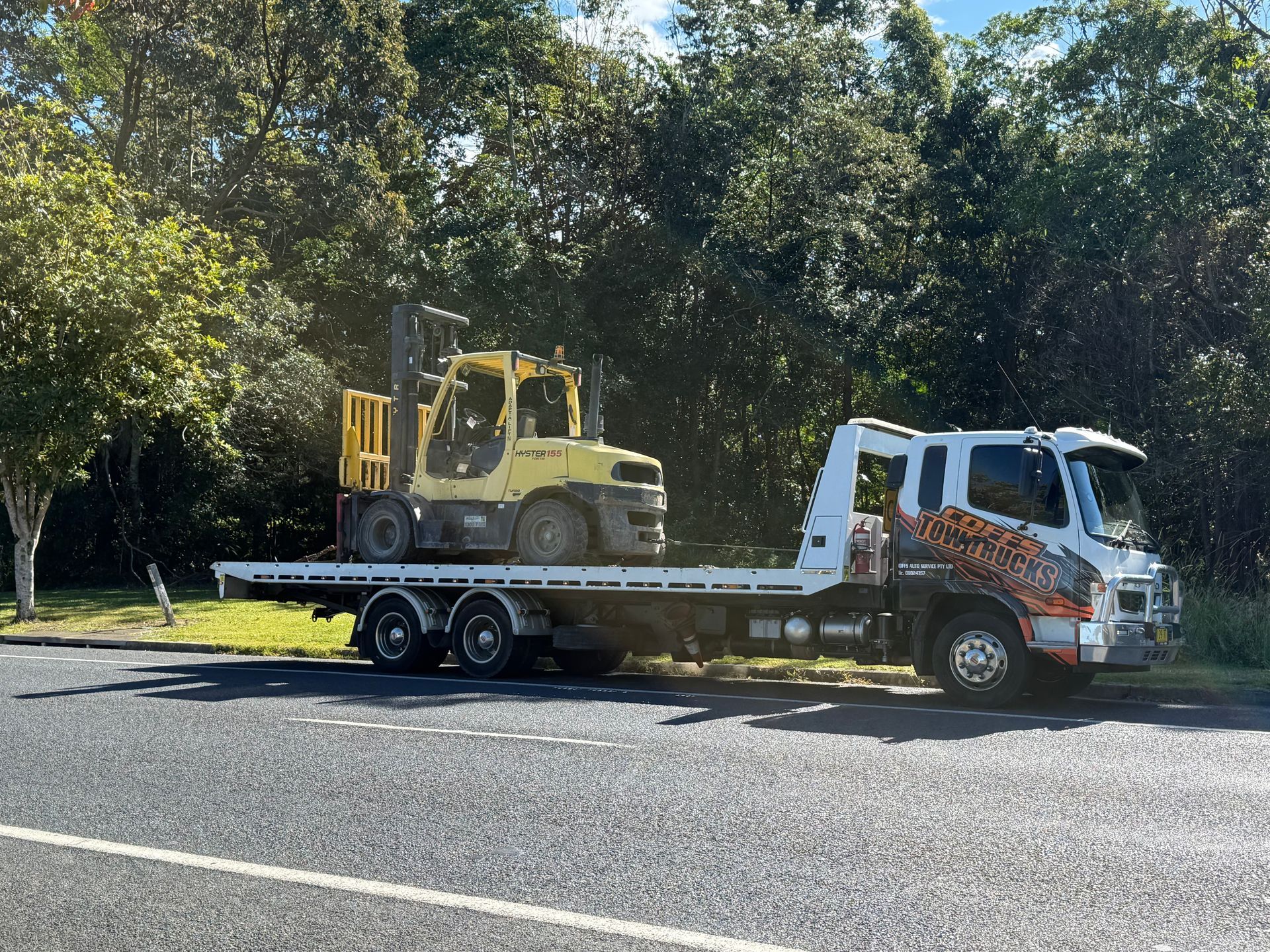 Tow Truck Hauling A Yellow Bulldozer — Coffs Tow Trucks In North Boambee Valley, NSW