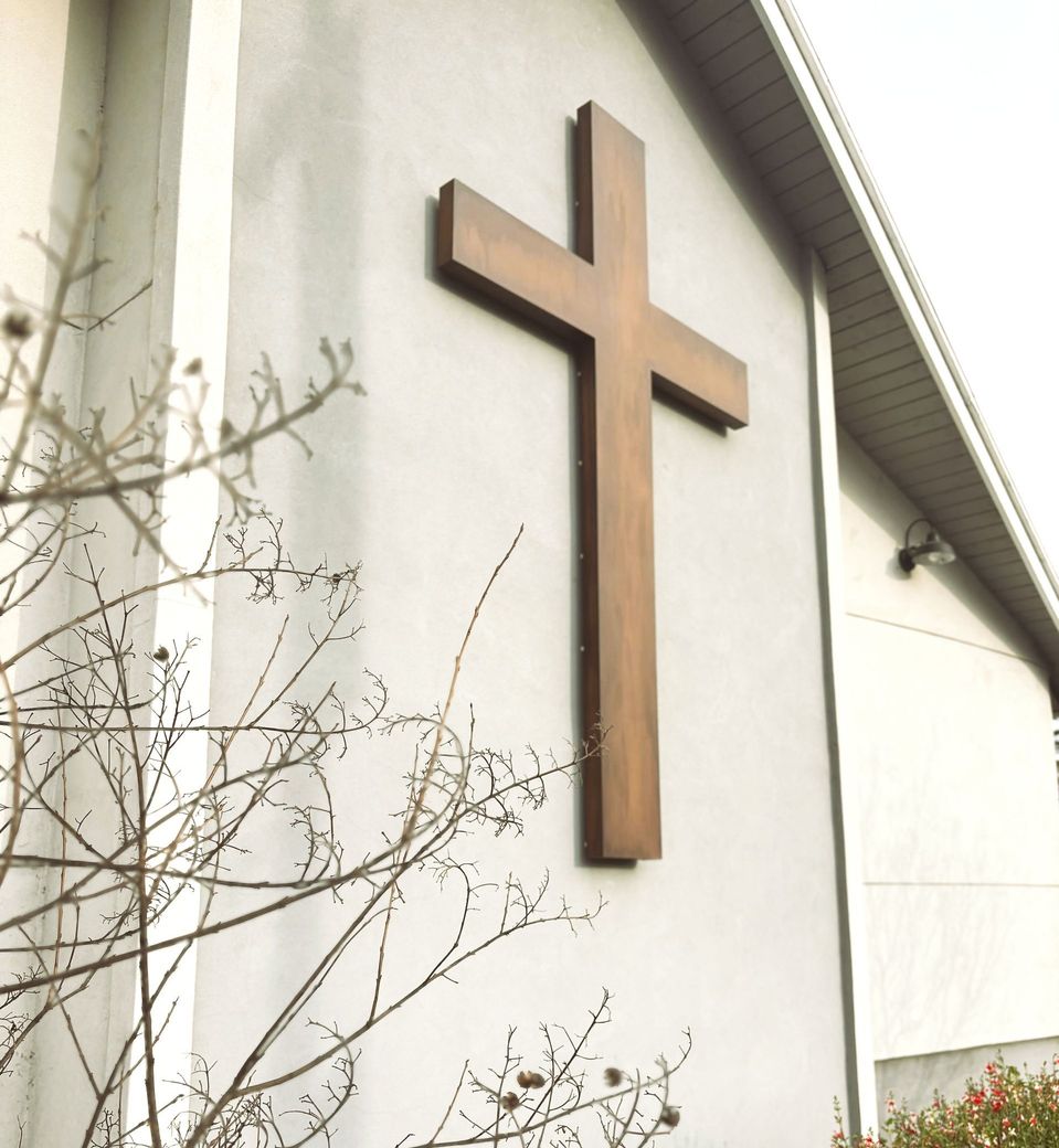 A large wooden cross on the side of a building