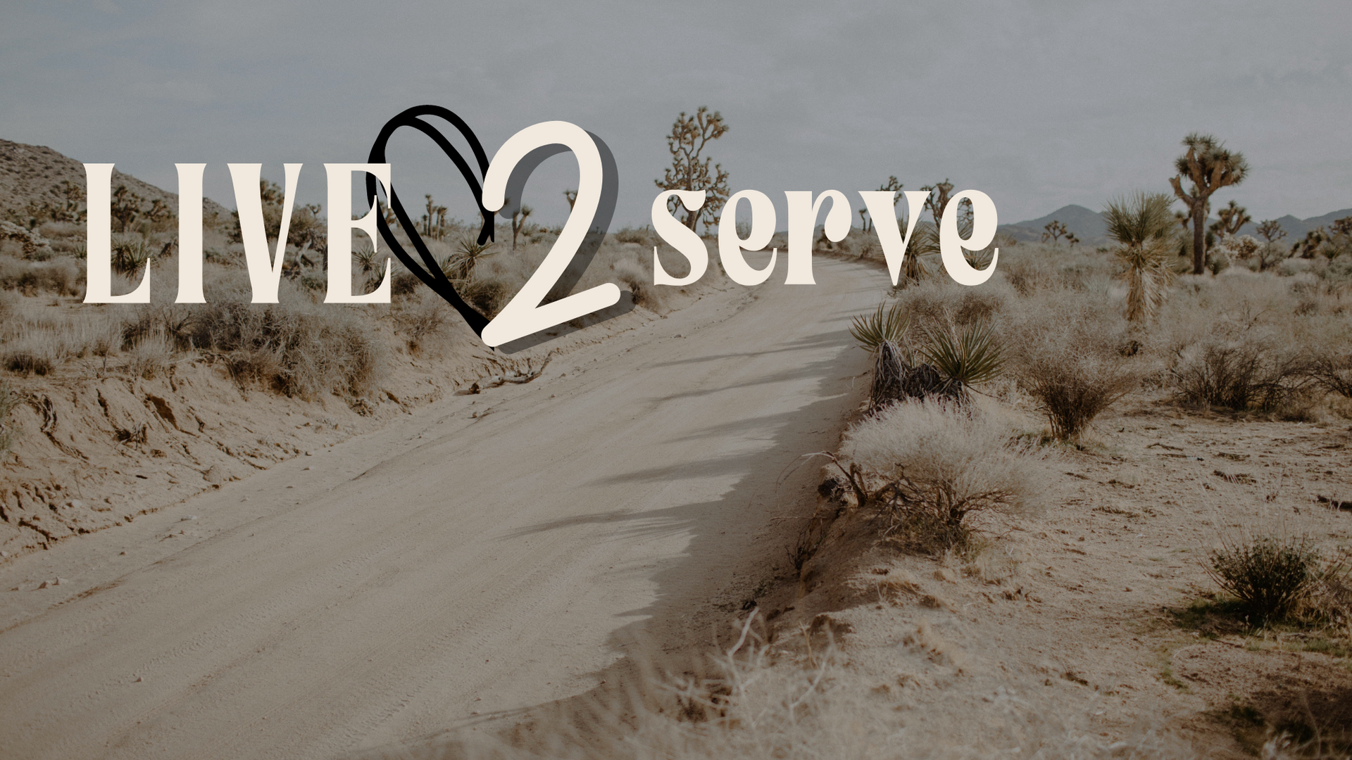 A desert road with the words live 2 serve on it
