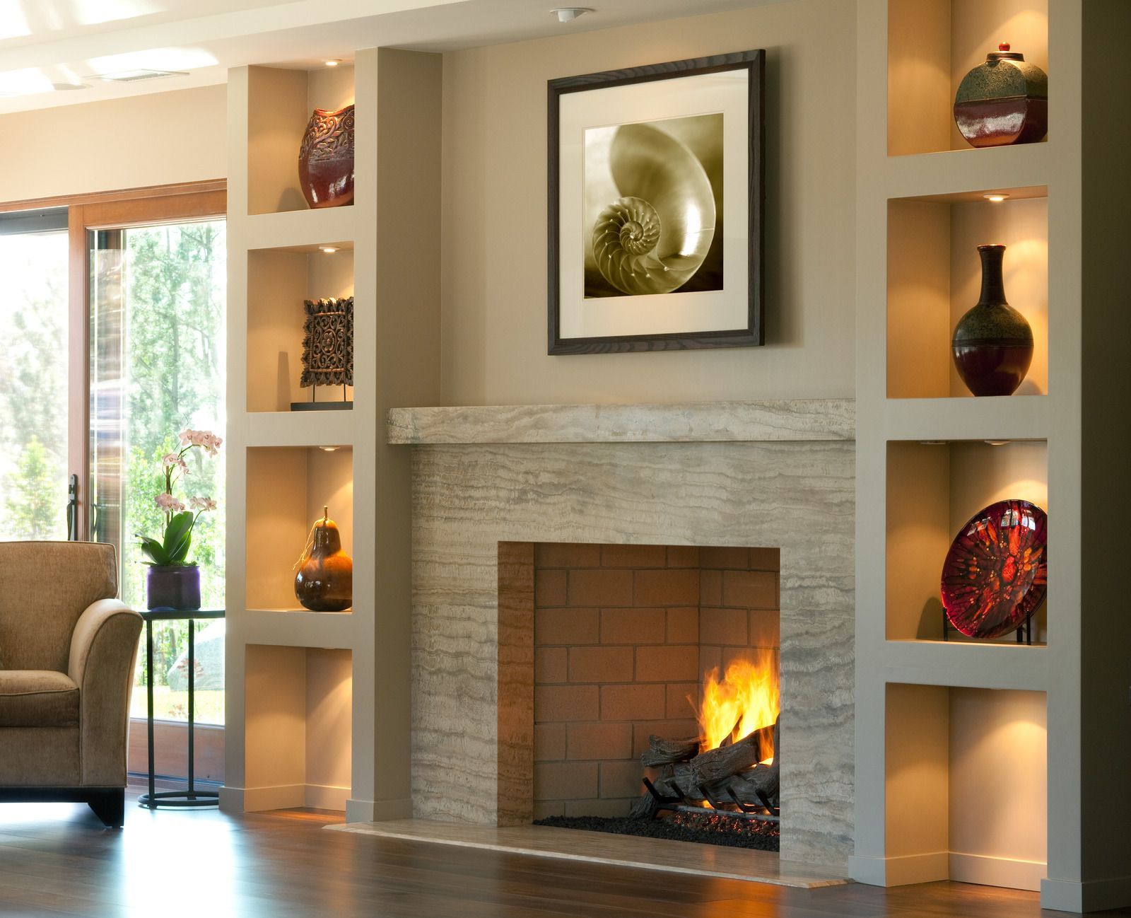 Elegant living room with a lit fireplace, built-in shelves, and decorative vases in warm lighting