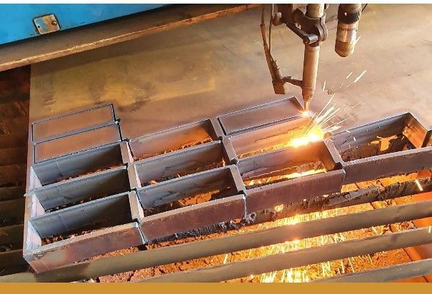 A Man Is Welding a Piece of Metal on A Piece of Wood — Agriweld Engineering in Dubbo, NSW