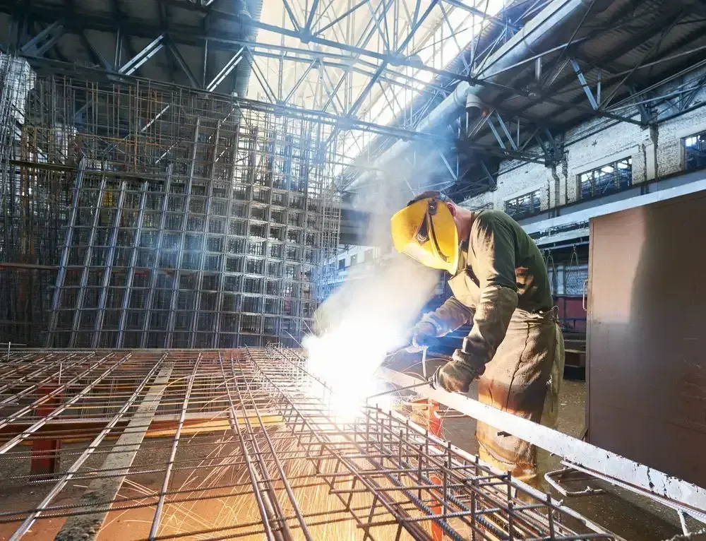 Professional welder working on structural steel fabrication in Dubbo, NSW