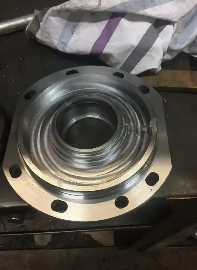 A Metal Ring With Holes In It Is Sitting On A Table — Agriweld Engineering in Dubbo, NSW