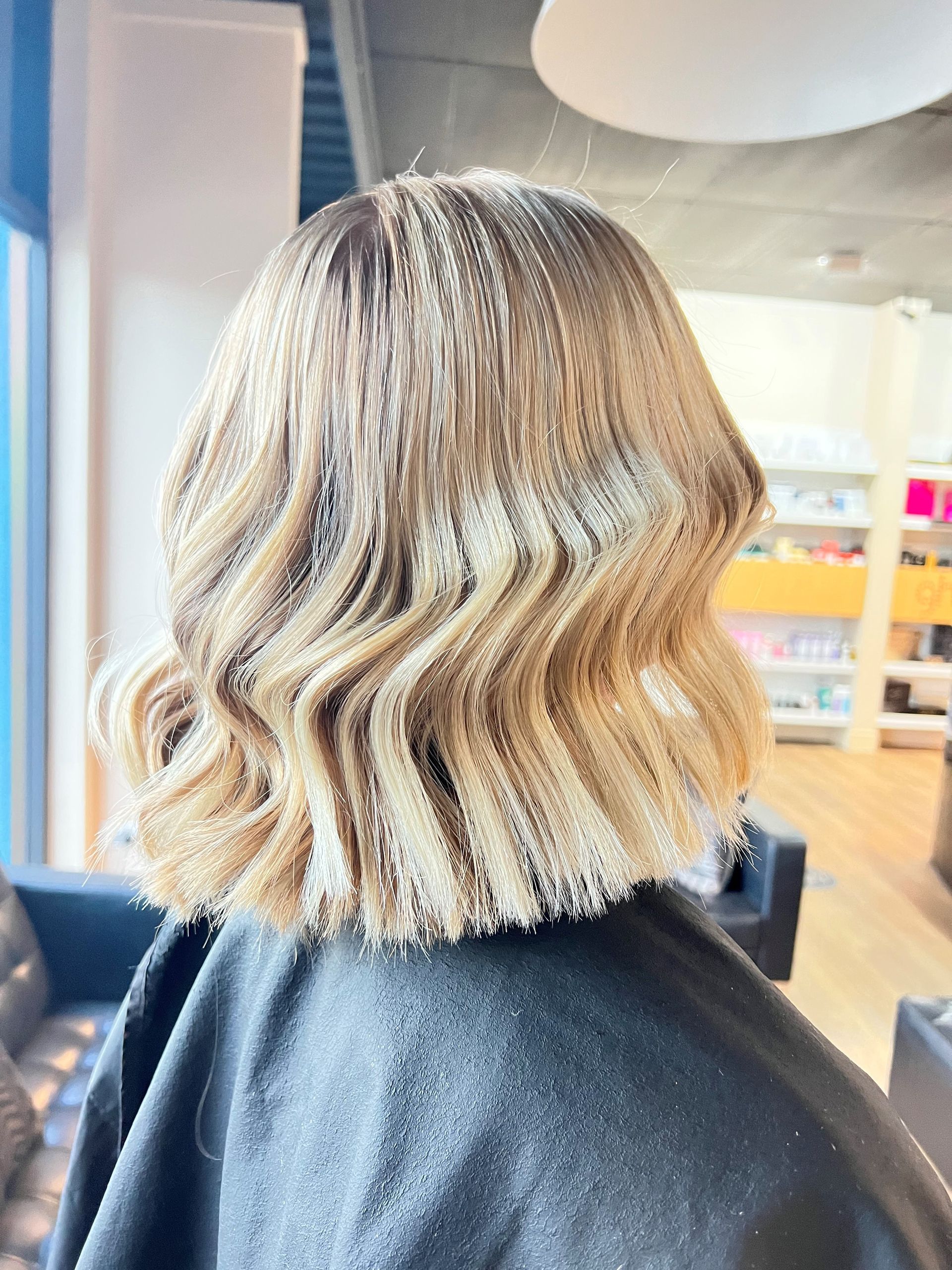 Woman With Long, Auburn Hair Styled In Loose Waves, Wearing A Black Salon Cape — Gina T Hair & Beauty In Mackay, QLD