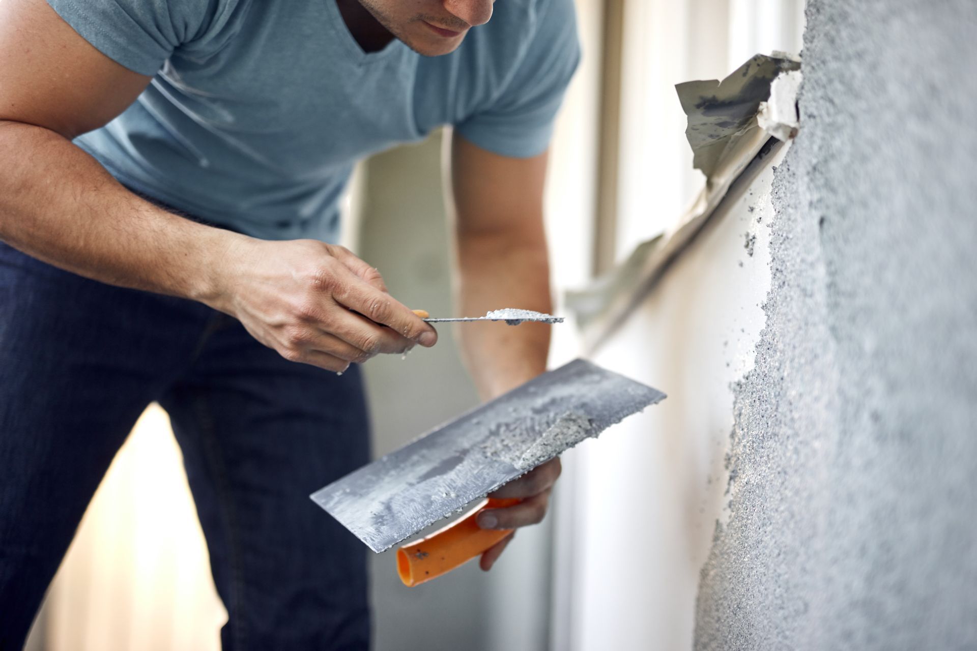 Man working on a house facade.