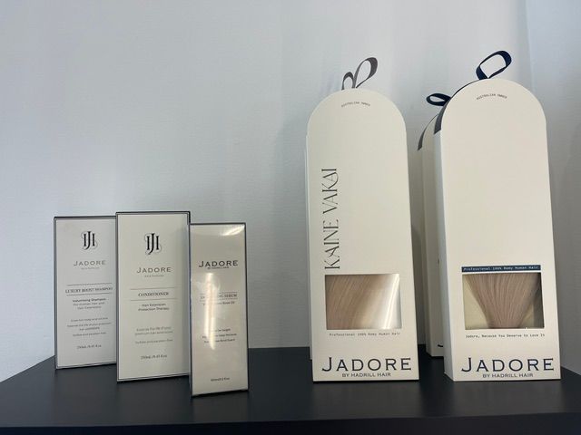 Perfume gift boxes and bottles on a table against a gray wall