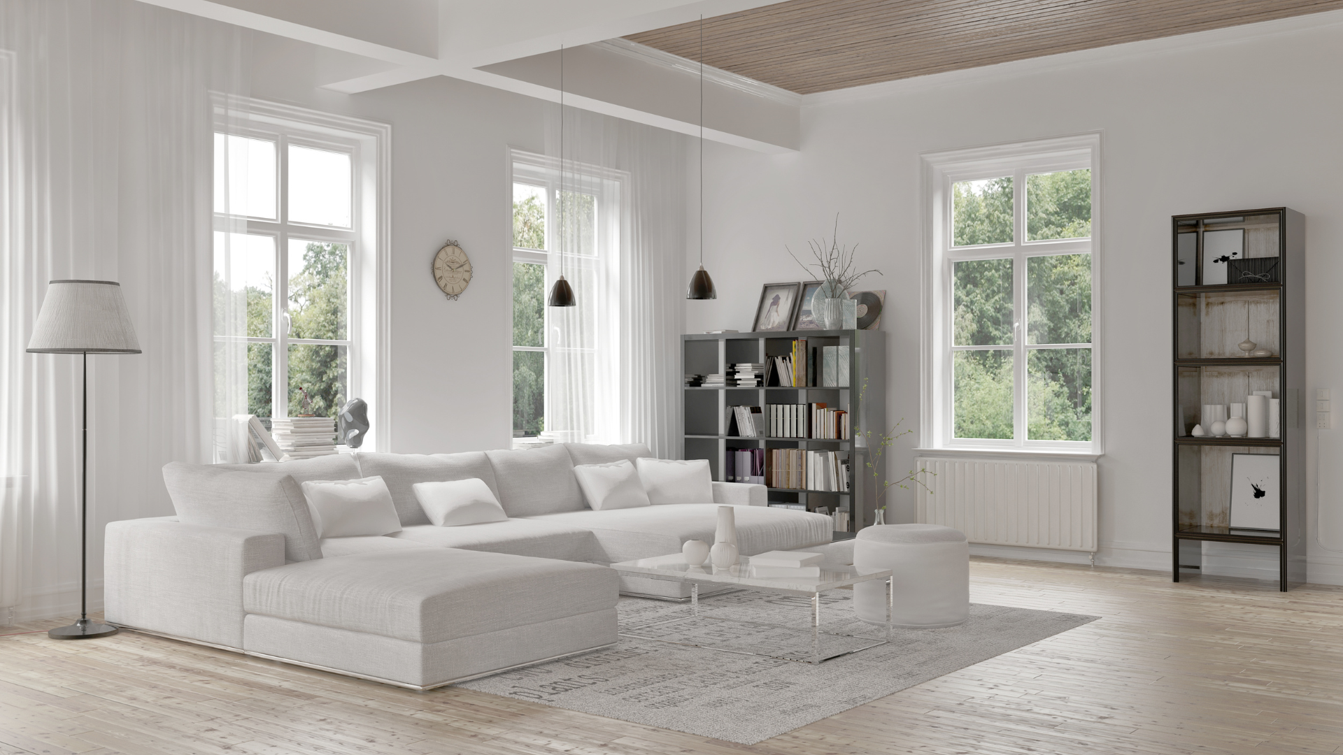 Bright minimalist living room with white sofa, rug, tall windows, and black shelving units