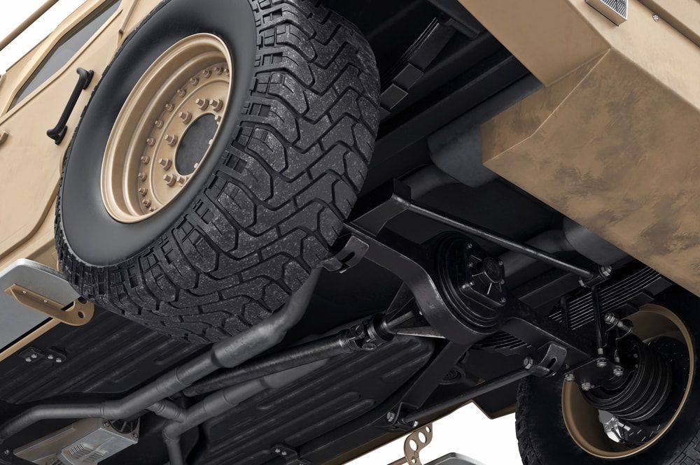 The Underside Of A Military Vehicle With A Spare Tire Attached To It — Evco Automotive in South Albury, NSW