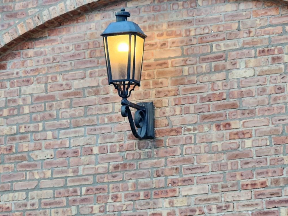 A brick wall with a lamp on it