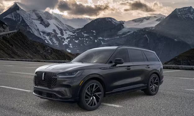 Black Lincoln Corsair SUV parked on road with mountains in the background.