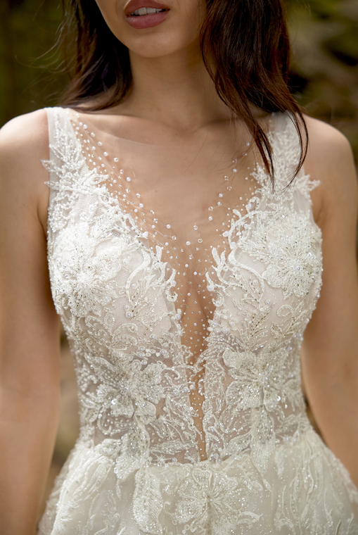 A woman is trying on a wedding dress in a bridal shop.