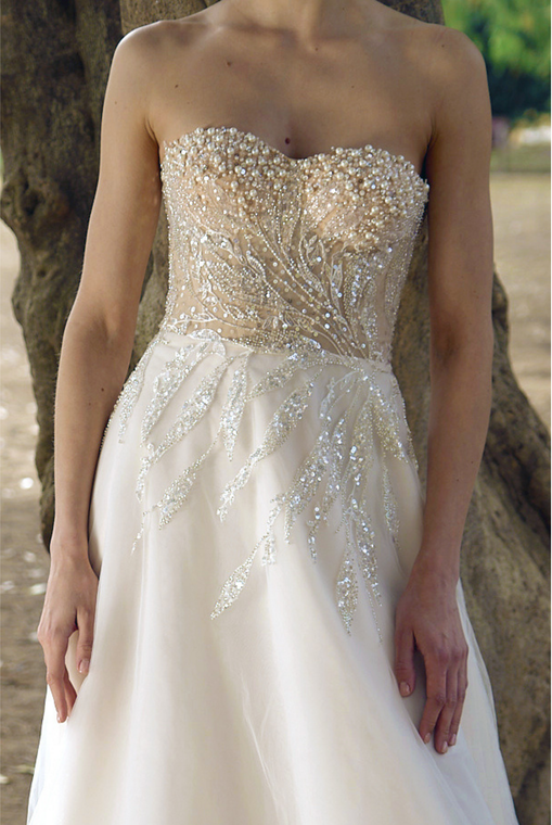 A woman is trying on a wedding dress in a bridal shop.