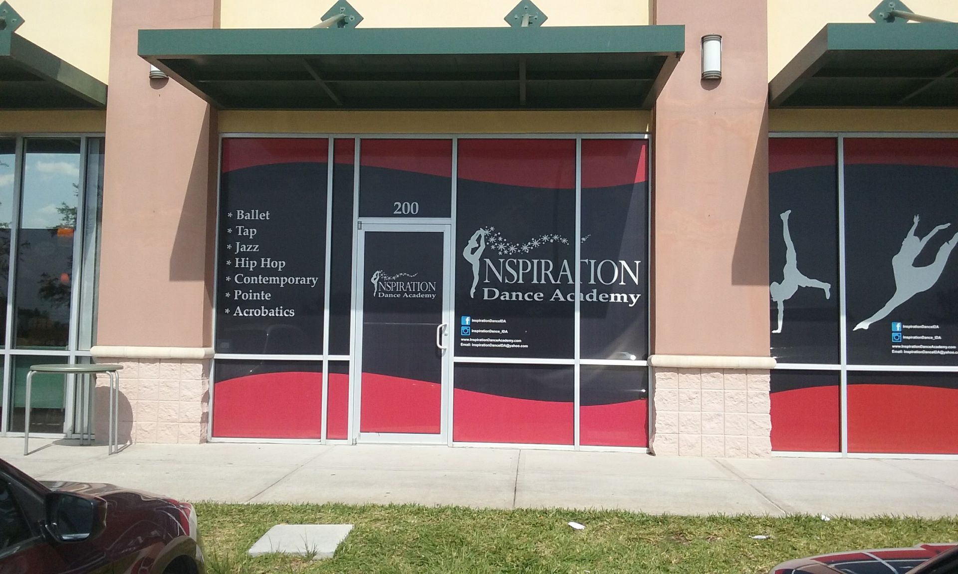 Dance studio storefront with red and black accents, a green awning, and the name 