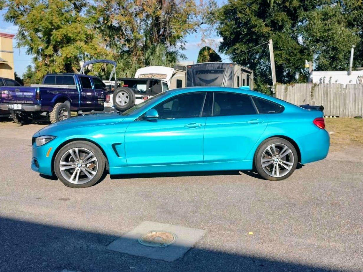 Bright blue BMW sedan parked outdoors.