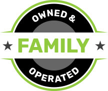 A green and black circle with the words `` owned and family operated '' written inside of it.
