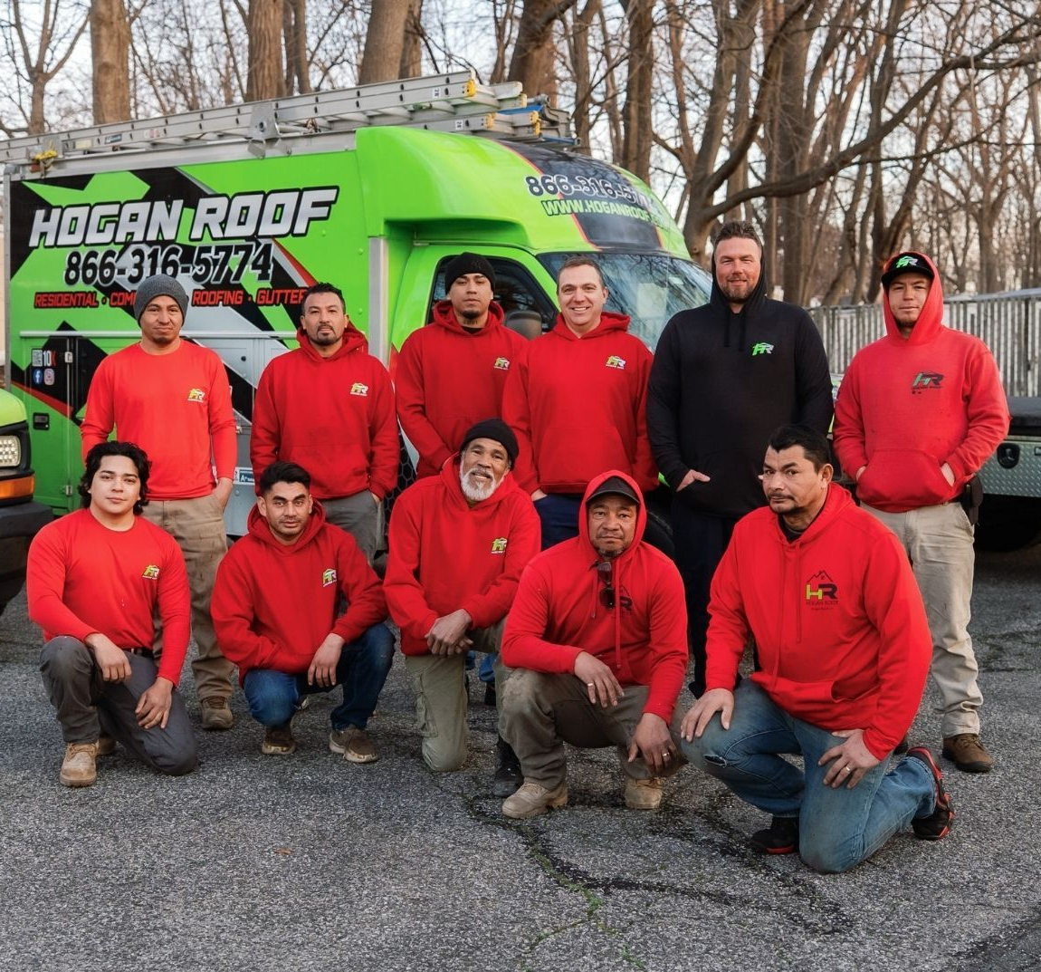A group of people are posing for a picture in front of their trucks.