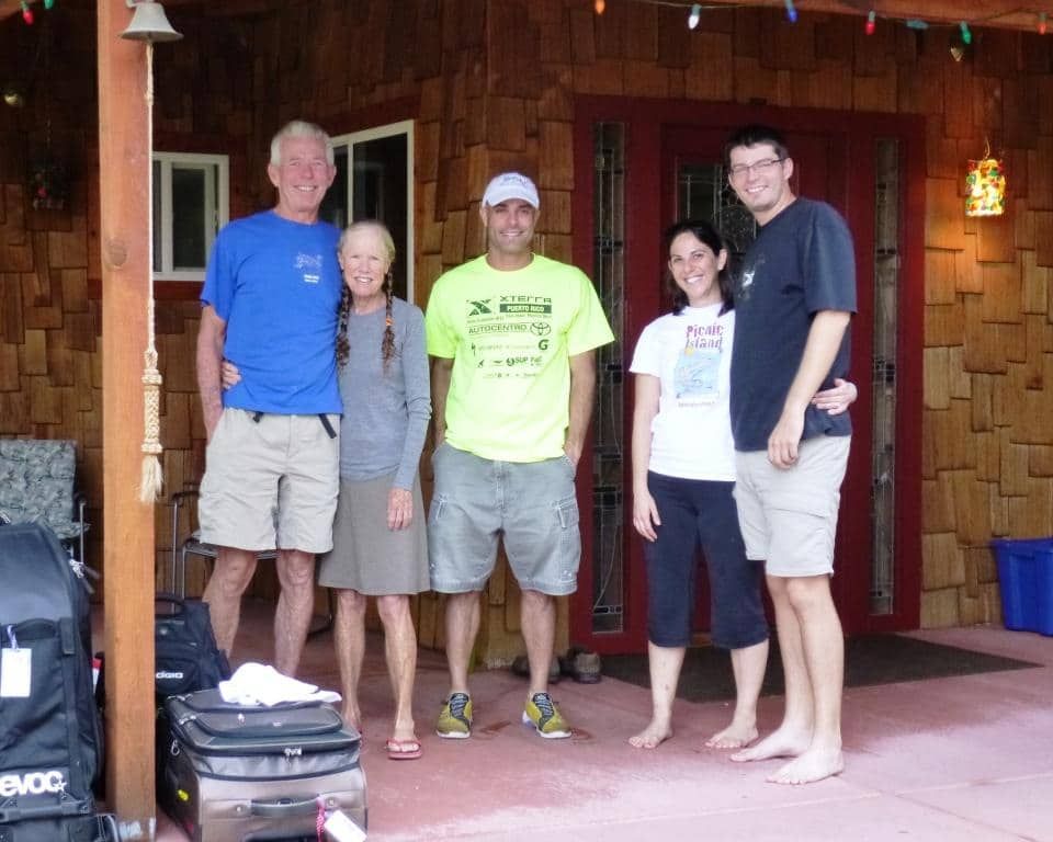 A group of people standing on a porch with a bag that says evoo on it