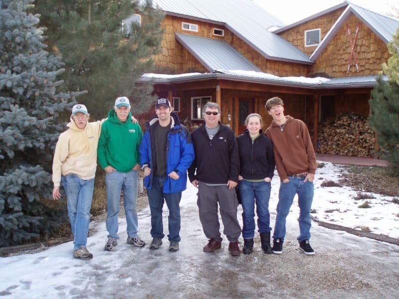 A group of people standing in front of a house