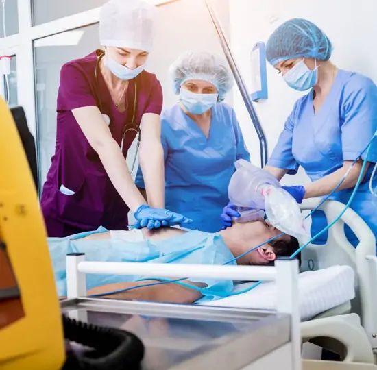 Medical staff performing CPR on a patient in a hospital room.