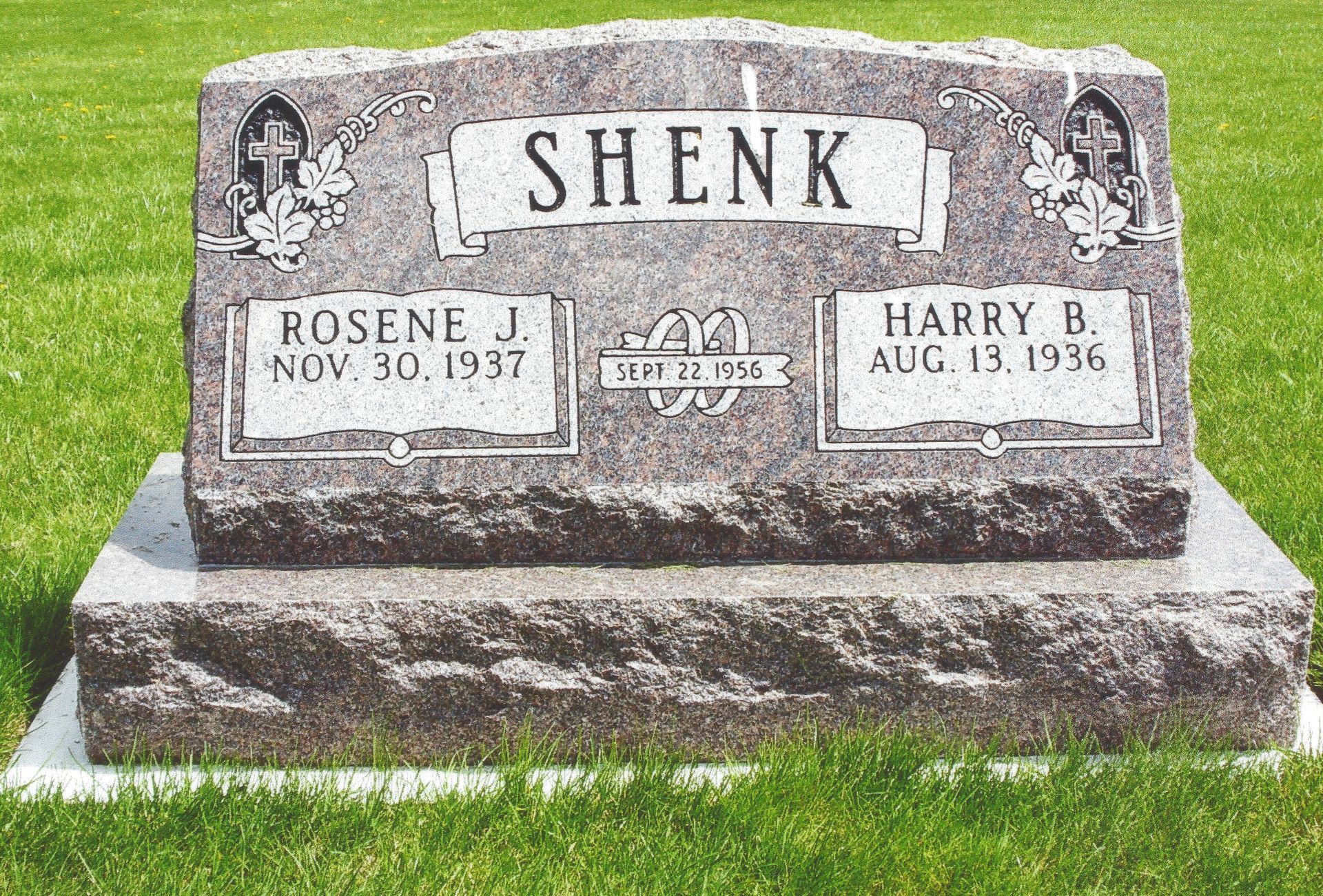 Gray gravestone in a grassy cemetery, engraved “SHENK” with names Rosene and Harry B. on plaques.