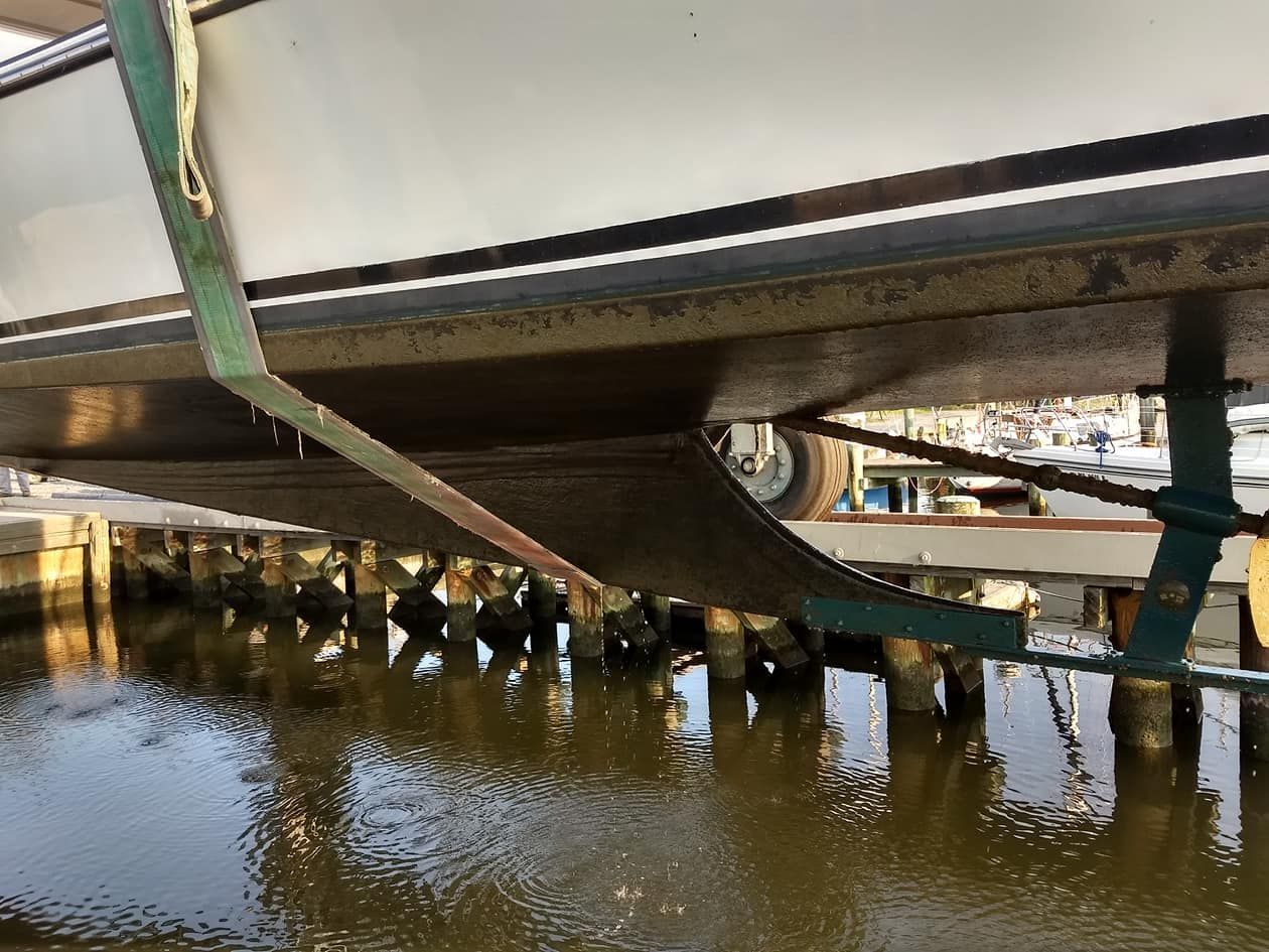 A boat is tied to a dock in the water.
