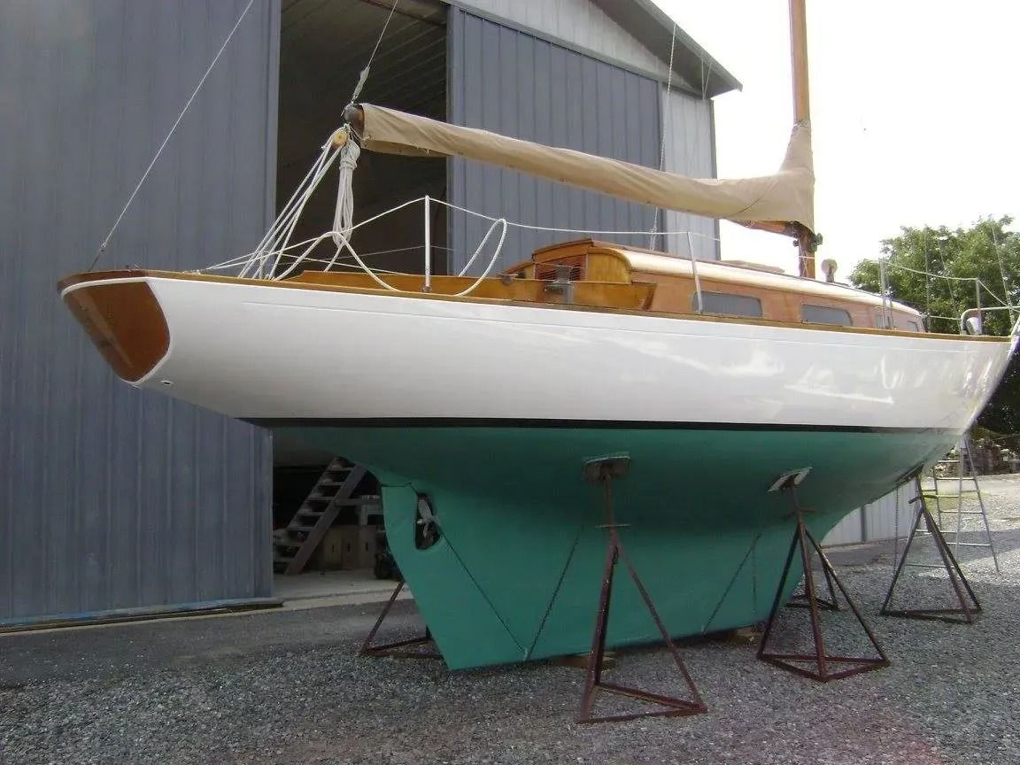 A sailboat is sitting in front of a building