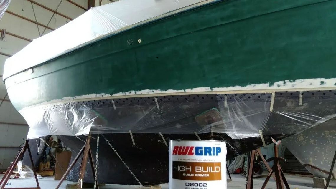 A boat is being painted with buzz grip paint
