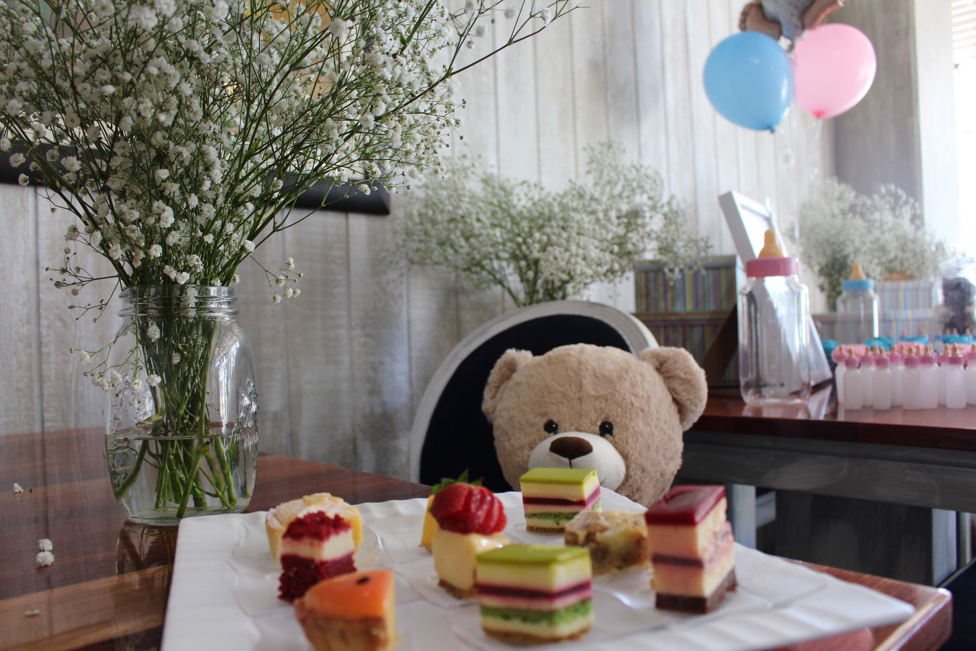 A Teddy Bear Is Sitting on A Table Next to A Plate of Desserts — Chop 'n Chill in Port Macquarie, NSW