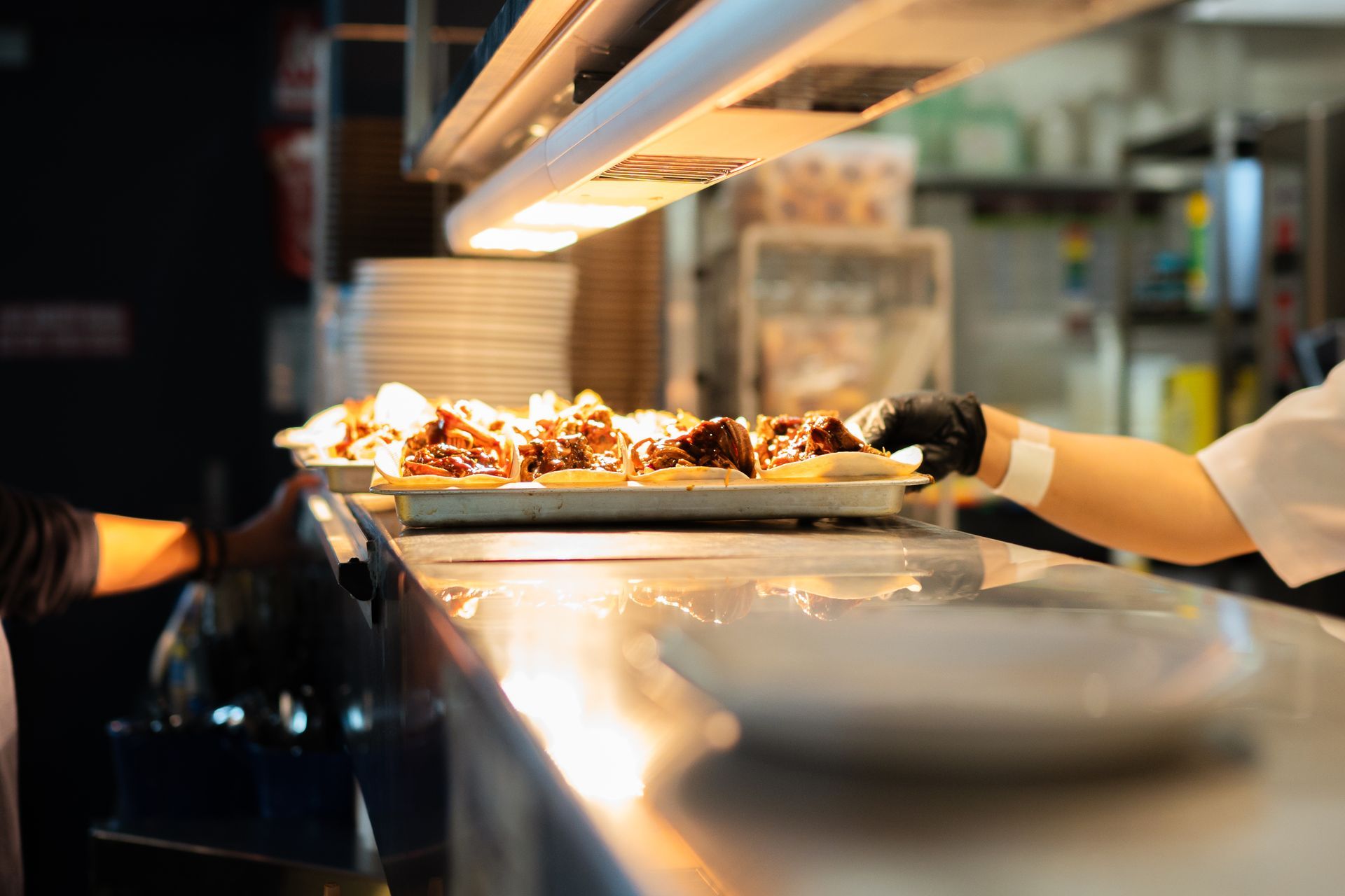 A Person Is Holding a Tray of Food in A Kitchen — Chop 'n Chill in Port Macquarie, NSW
