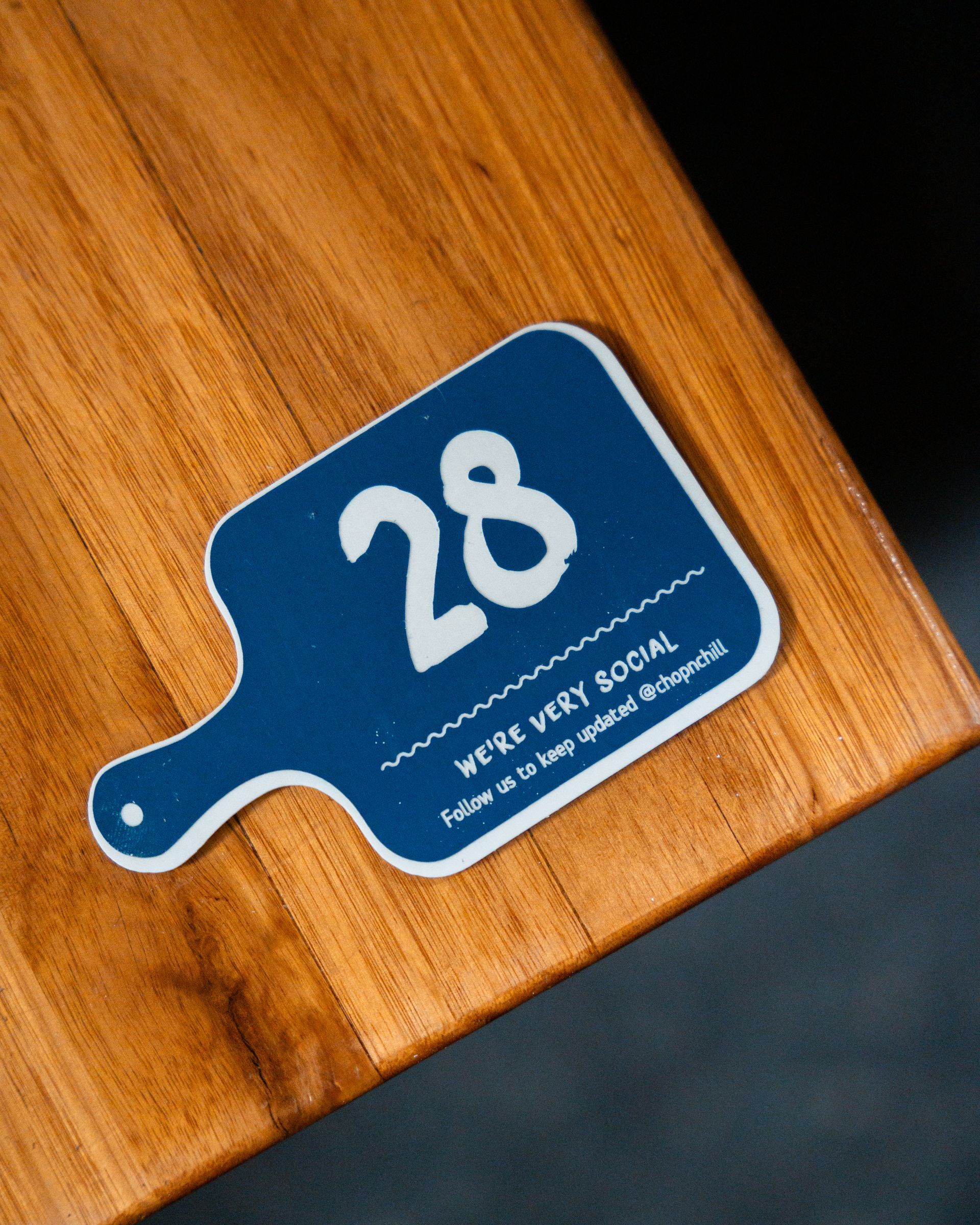A Blue Cutting Board with The Number 28 on It — Chop 'n Chill in Port Macquarie, NSW